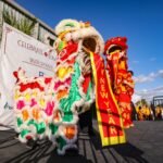 a lion dance is being performed in front of a crowd